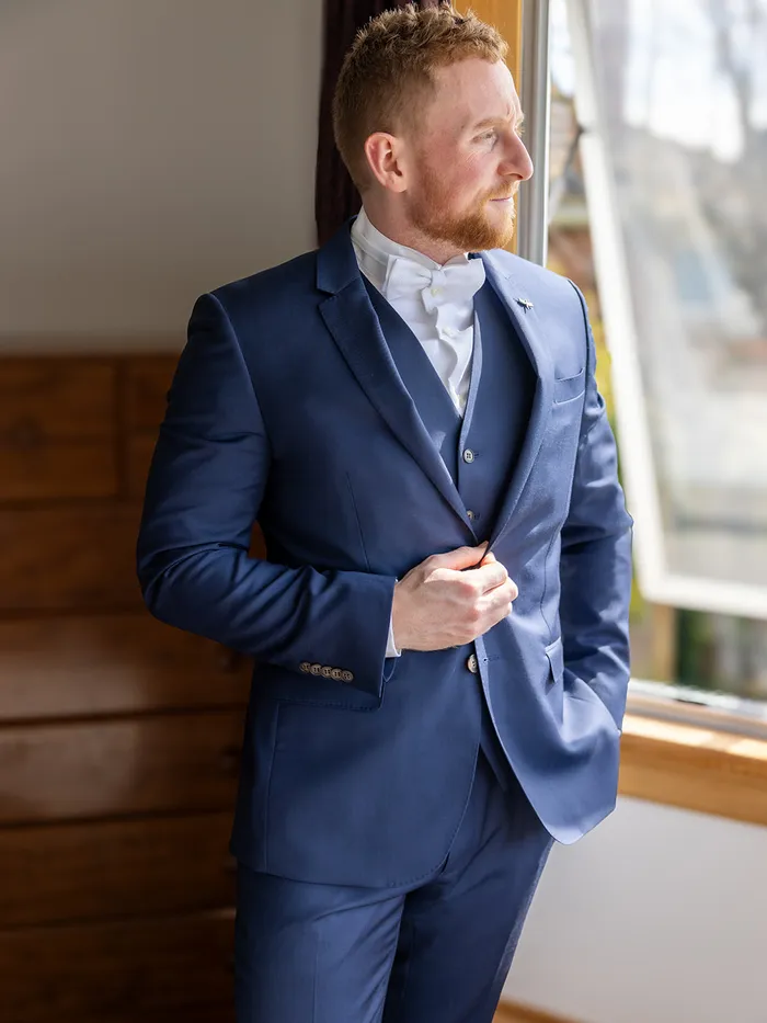 Groom by a window before the ceremony, Eye Photography wedding portfolio