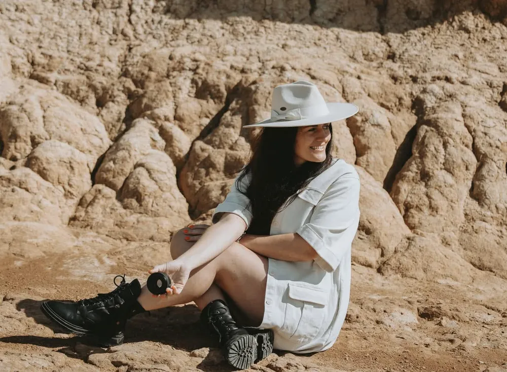 Anna, the photographer behind Eye Photography, sitting outdoors with her camera